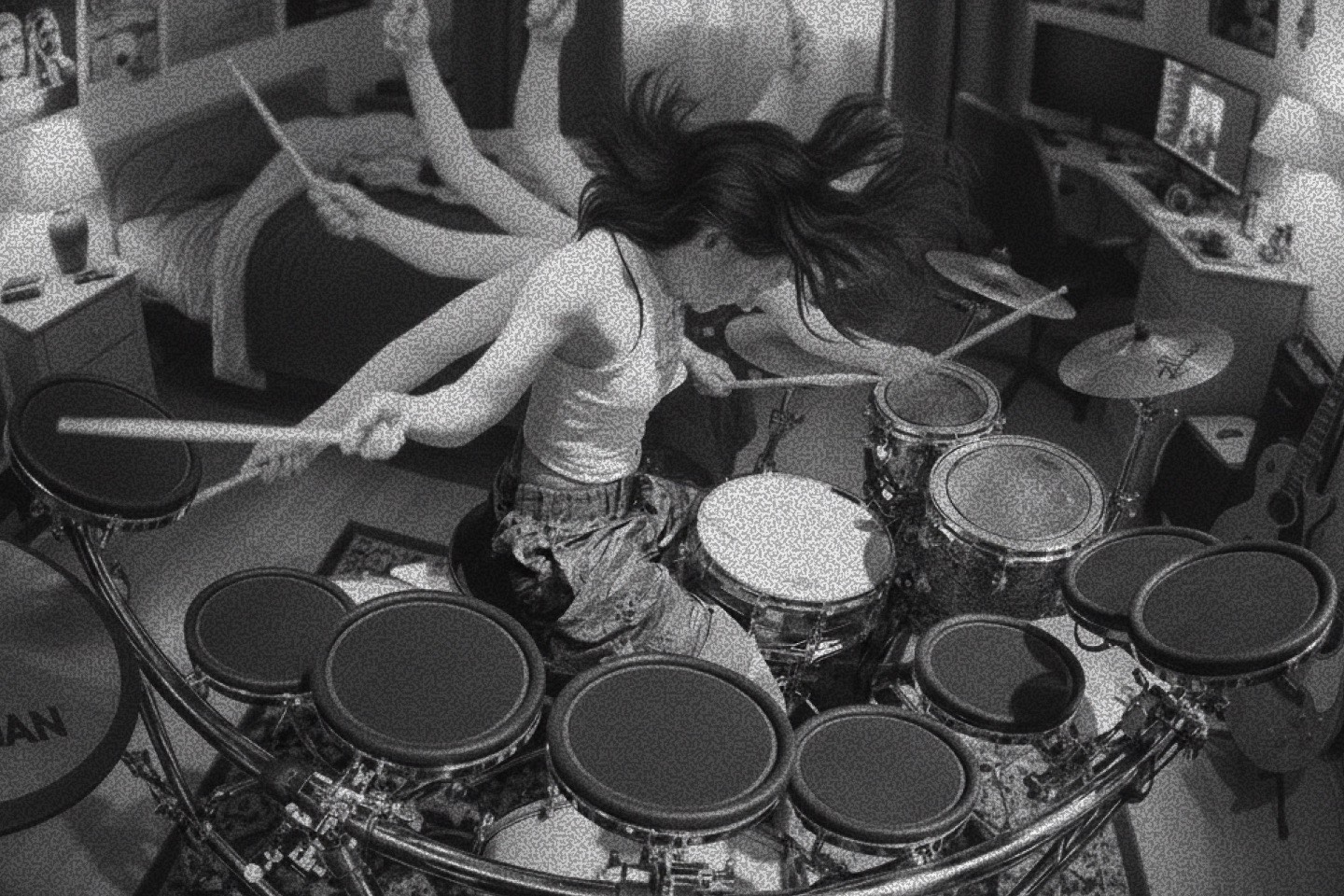 Drummer practicing energetically on an electronic drum kit at home.